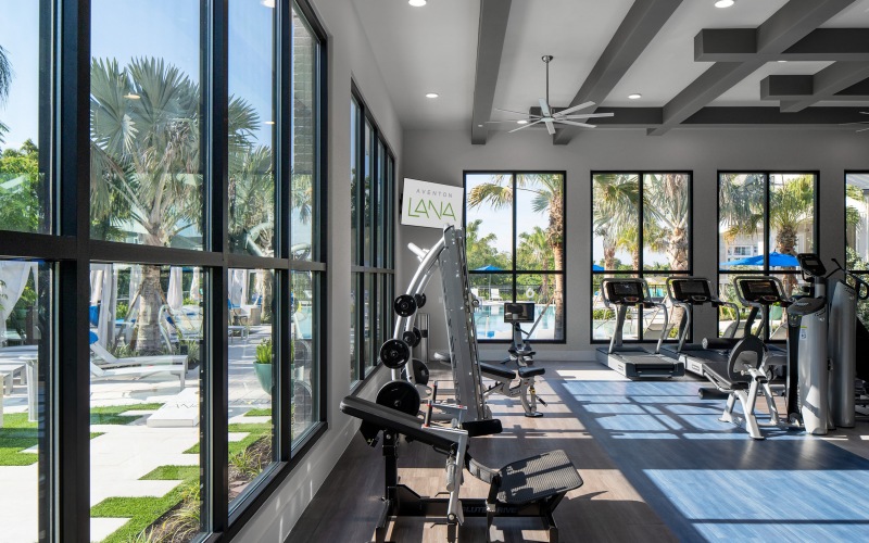 Large floor to ceiling windows in fitness center at Aventon Lana